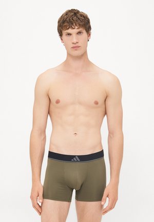 Olijfgroene boxershorts van rekbaar materiaal, met een zwarte tailleband met een zilveren logo en twee zijnaad voor structuur.