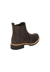 Braune Leder-Stiefelette mit elastischen Seitenpanelen, runder Zehe und einer strukturierten Gummisohle. Mit einem beigen Akzent um die Sohle.