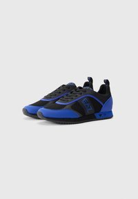 Black and blue athletic shoes with mesh material, textured accents, tapered design, and logo detail on the side and heel.
