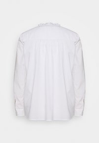 Camicia bianca a maniche lunghe con un colletto testurizzato, schiena arricciata e dettagli sui polsini con bottone. Tessuto liscio con una vestibilità classica e rilassata.