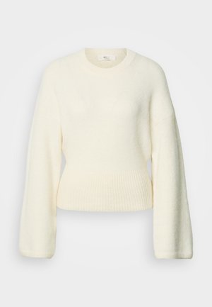 Pull tricoté crème à manches longues avec une taille côtelée et un col rond, présenté sur un fond blanc.