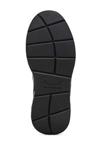 Schwarze Gummisohle mit strukturierten Oberflächen, die ein geometrisches Muster aufweist und in der Mitte das Branding "Voile Blanche" zeigt.
