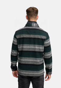 Grøn- og gråstribet flannel skjorte med krave, knapmanchetter og en afslappet pasform. Mønsteret veksler mellem tykke og tynde striber.