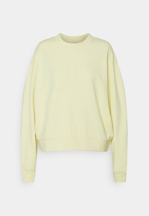 Sweat-shirt à col rond jaune clair avec manches longues et poignets et ourlet côtelés, présenté sur un fond uni.