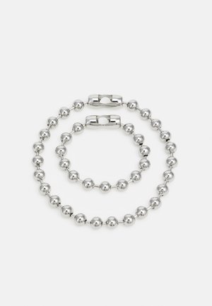 Silver metal bracelet set featuring two strands of alternating round beads with a smooth finish and a magnetic clasp.