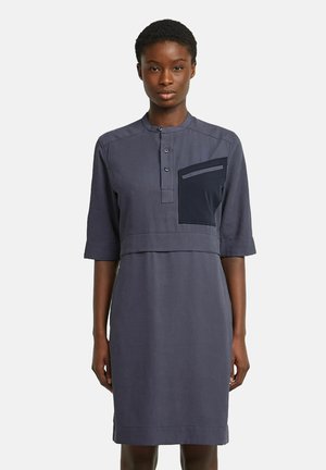 Navy blue dress with a henley neckline, short sleeves, a front pocket, and a relaxed fit; made of smooth fabric with a clean finish.