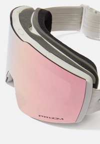 Skidglasögon med en rosa spegelobjektiv, vit ram och mjuk skumvaddering på insidan. Justerbar rem i ett strukturerat grått material.