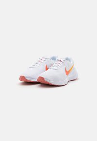 White athletic shoes with mesh upper, orange and yellow accents on the sides, and pink sole. Features traditional lacing system.