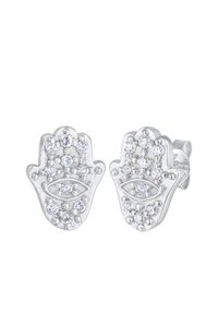 Silberne Ohrringe in Form einer Hamsa-Hand, verziert mit klaren Steinen, die ein zentrales Augen-Motiv und eine polierte Oberfläche aufweisen.