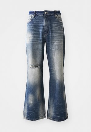 Blue flared jeans with faded areas and distressed knee detail. Made of denim, featuring a button closure and five-pocket design.