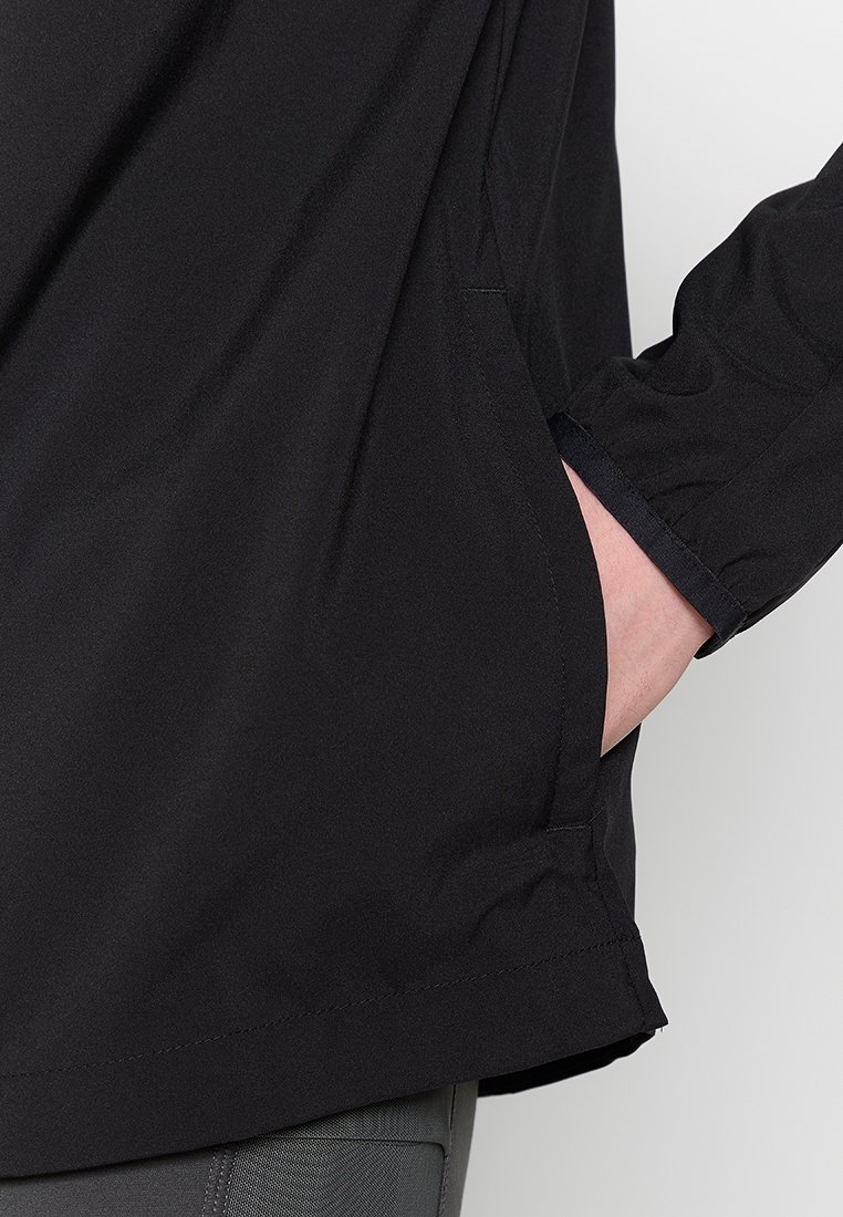 Zwarte longsleeve shirt met elastische manchetten en zijzakken. De stof is glad en lichtgewicht, met een comfortabele pasvorm en een subtiele zoomdetails.