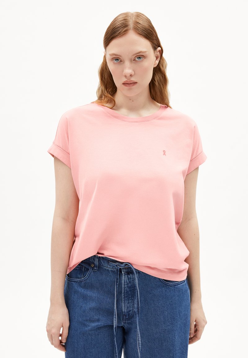 T-shirt rosa chiaro a maniche corte con taglio comodo e risvolti. Presenta un piccolo logo ricamato sul petto. Materiale in morbido cotone.