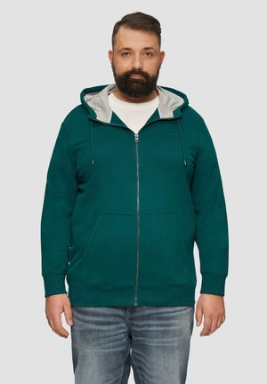 Teal zip-up hoodie met een lichtgrijze binnenkant, voorzien van trekkoorden, een voorzak en geribde mouwen, gedragen over een wit T-shirt.
