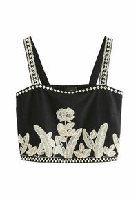 Top corto negro con bordados florales blancos y acentos geométricos. Presenta tirantes anchos y una tela texturizada.