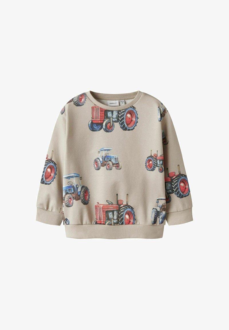 Bēšas krāsas džemperis ar traktora druku sarkanā un zilā krāsā, ar apaļu kakla izgriezumu, garām piedurknēm un ribota lāpstiņu. Mīksts kokvilnas materiāls.