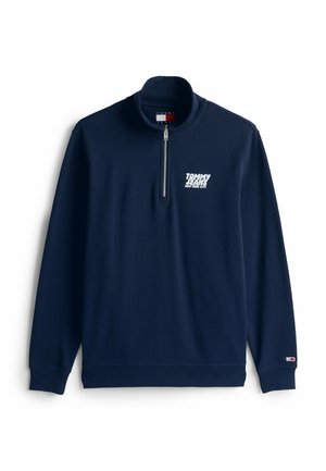 Granatowy sweatshirt z półzamkiem, wykonany z mieszanki bawełny, z białym logo na klatce piersiowej, ściągaczami przy mankietach i wykończeniem dołu.