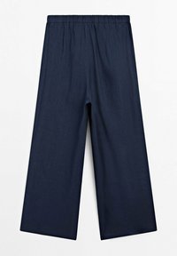 Pantalons larges bleu marine avec une taille élastique, fabriqués en tissu léger, présentés à plat sur un fond blanc.