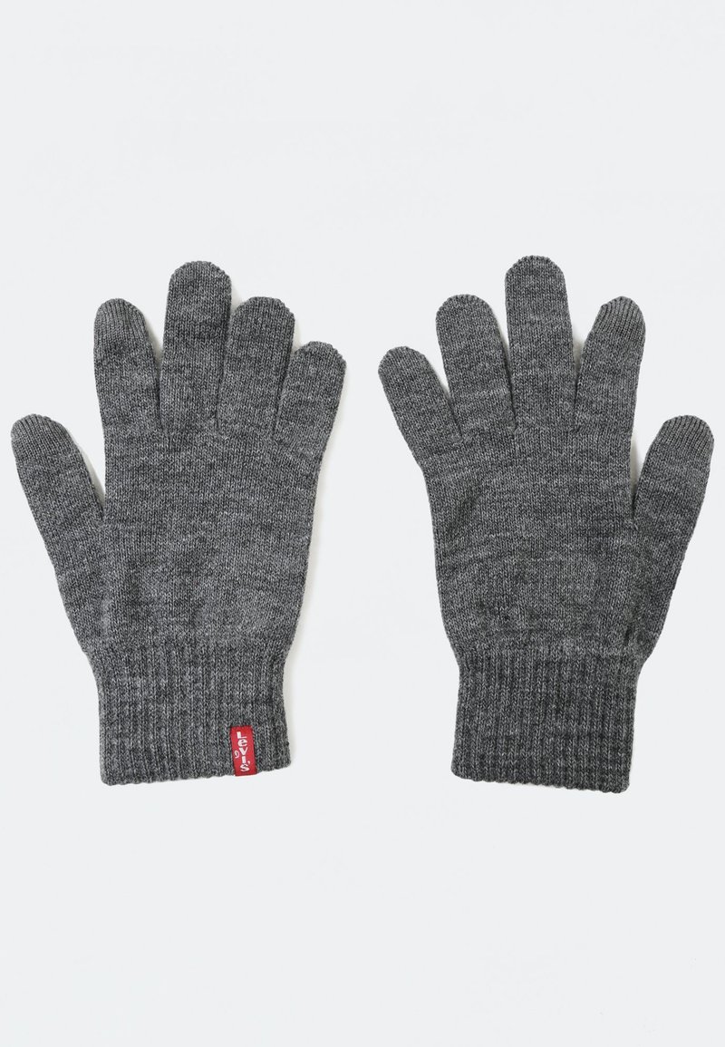 Gray knitted gloves with a ribbed cuff. Textured fabric and a small red tag on the wrist enhance the design. Suitable for cold weather use.