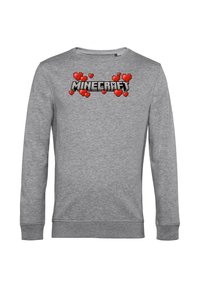 Felpa grigia con la scritta "MINECRAFT" in testo nero pixelato, decorata con cuori rossi pixelati sopra il testo.