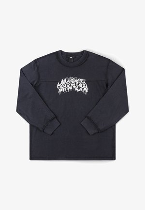 Melna kokvilnas krekls ar garām piedurknēm, uz krūtīm kontrastējošs balts grafiskais logotips un ribota apkakle un aproces.