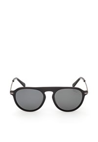 Lunettes de soleil style aviateur à monture noire avec verres polarisés foncés et branches métalliques fines sur fond blanc.