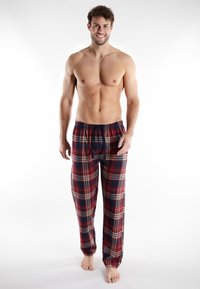 Pantalones de pijama a cuadros en rojo, azul marino y beige; tela suave con una cinturilla elástica y cordón; corte holgado; cuenta con bolsillos a los lados.