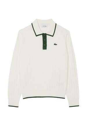 Polo blanc à manches longues avec col et boutons verts, texture côtelée, et petit logo Lacoste vert sur la poitrine gauche.