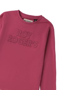 Camicia rosa a maniche lunghe realizzata in materiale morbido con ricamo a rilievo "ROY ROGER'S" sul davanti. Scollo rotondo semplice, senza decorazioni.