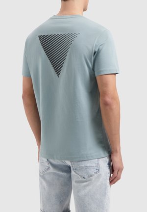 Light blue cotton t-shirt with a black striped triangle graphic on the back. Short sleeves and rounded neckline. Plain front.