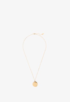 Collier délicat en chaîne d'or avec un pendentif rond et lisse, orné d'une subtile ligne gravée en diagonale.