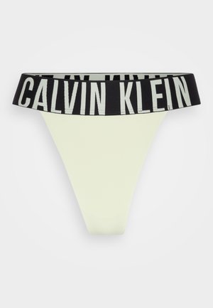 Tanga Calvin Klein v svetlo zeleni barvi, z širokim črnim pasom z kontrastnim belim tiskom logotipa. Gladka tekstura.
