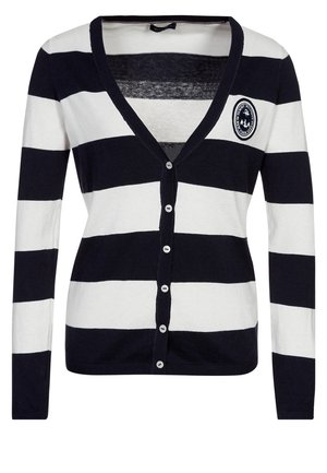 Cardigan à manches longues rayé horizontal noir et blanc avec des boutons sur le devant et un petit patch circulaire avec une ancre sur la poitrine.