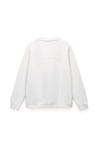 White sweatshirt with long sleeves, crew neckline, and a subtle horizontal seam detail at the back. Smooth fabric texture, relaxed fit.
