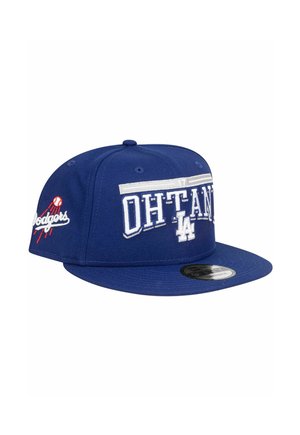 Blue baseball cap with a flat brim, featuring "OHTANI" and "LA" embroidered in white, alongside a Dodgers logo in red and white on the side.