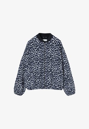 Long-sleeve, zip-up jacket with black and white irregular spotted pattern and black ribbed collar and cuffs.