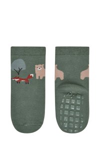 Green cotton socks featuring a red fox, a bear, and a tree design. The soles have textured, non-slip accents for grip.