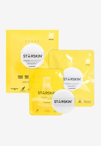 Produits de peeling moussants STARSKIN dans un emballage jaune vif, comprenant un puff rond et divers sachets avec un texte clair et des logos.