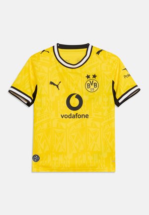 Żółta koszulka piłkarska Borussia Dortmund z czarnymi logo Puma, sponsorem Vodafone i czarno-białą lamówką na kołnierzu i rękawach.