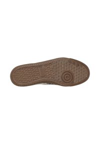 Brown rubber shoe sole with textured grip pattern, circular detail near the toe, and rectangular logo label in the center.