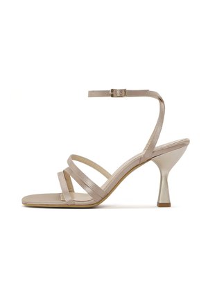 Sandal con tacco alto beige con cinturini, dotata di un tacco metallico e tre cinturini sottili sul piede, chiusura con fibbia alla caviglia.