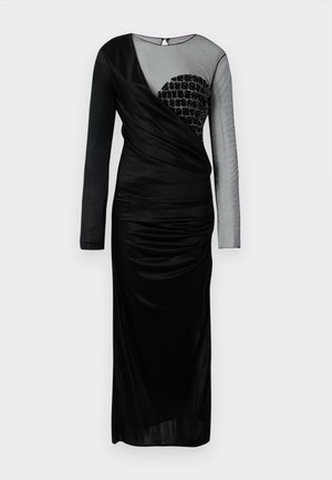 Schwarzes Langarmkleid mit einem durchsichtigen Paneel und verzierten geometrischen Designs auf einer Seite. Der drapierte Stoff schafft eine figurbetonte Silhouette.