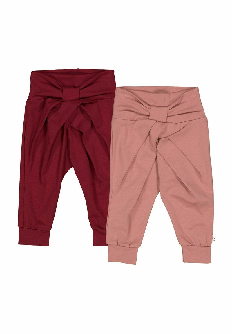 Two pairs of knotted pants, one in burgundy and the other in dusty pink. They feature a soft, stretchy fabric and tapered cuffs at the ankles.