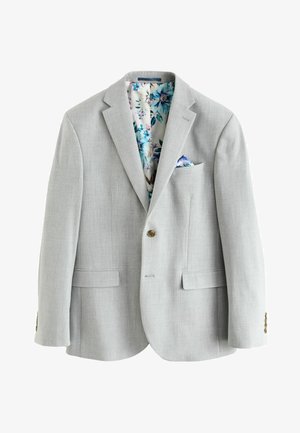 Svetlo šedý blejzer s textúrovaným povrchom; podšívka s kvetinovým vzorom v modrej, ružovej a zelenej farbe; obsahuje náprsné vrecko a hnedé gombíkové zapínanie.