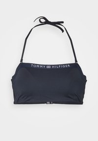 Top de bikini preto, feito de tecido suave, com alças ajustáveis e uma faixa com logotipo. Fecho nas costas para um ajuste seguro.