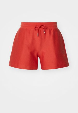Red athletic shorts with a textured fabric, drawstring waist, and subtle branding detail. Classic short shape, suitable for active wear.