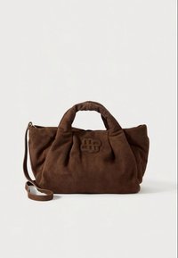 Hnědá kabelka z broušené kůže s měkkým, texturovaným povrchem, vybavená dvěma uchy a odnímatelným ramenním popruhem. Na přední straně je výrazné vyražené logo.