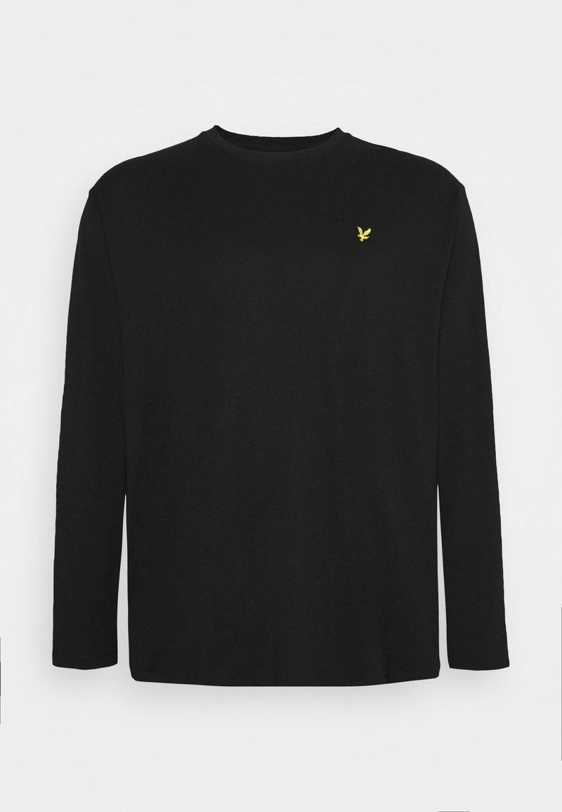 T-shirt noir à manches longues avec col rond et petit logo d'oiseau jaune sur la poitrine gauche, design uni sur fond gris clair.