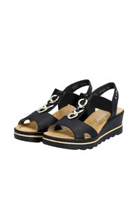 Sandali wedge neri con punta e tallone aperti, con accenti in catena metallica e cinturini elastici. Soletta testurizzata e suola leggera.
