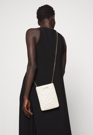 Valkoinen svetarilaukku, jossa on kultaketjuhihna, suorakulmainen muoto ja kohokuvioitu logoedustus etupuolella.