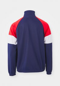 Mornarice s visokim ovratnikom, s crvenim, bijelim i crvenim panelima na ramenima. Glatka tekstura, elastične manžete i rub.